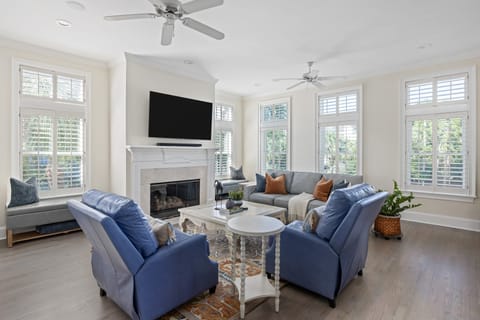 Bright living room with fireplace and plush seating.