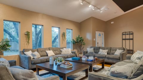 The living room features multiple windows for natural light.