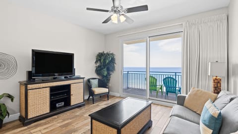 Unit 506: Bright living room with a Gulf view balcony.