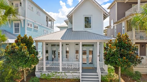 Front exterior of this charming coastal cottage with an inviting front porch.
