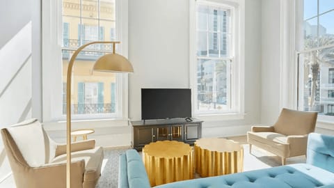 Bright and airy living room with plush seating and a TV to keep you entertained.