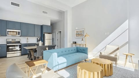 The open-concept living area offers seamless transitions from living to dining and kitchen areas.