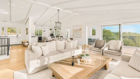 The living room features a fireplace, TV and ample seating. (Main house)