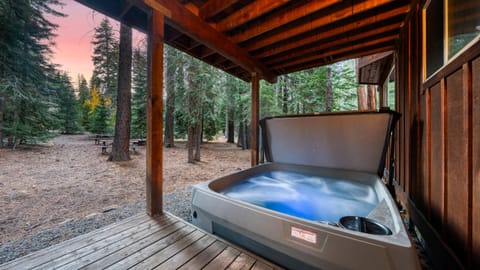 Outdoor hot tub under a covered deck.