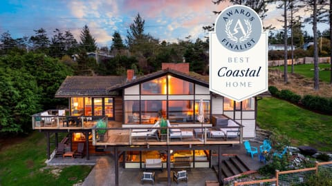 Aerial view showing home and coastline below.