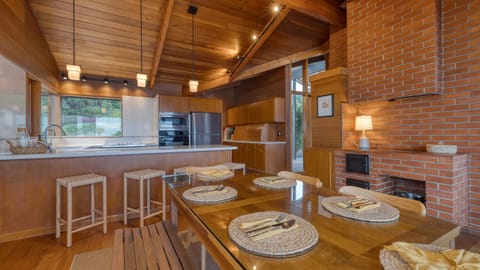 Cozy living area with brick fireplace and open beam ceiling.