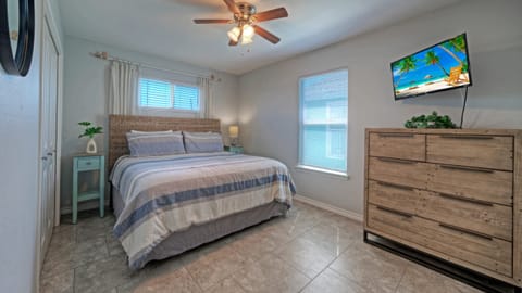 The primary bedroom features a king bed, TV and an ensuite bathroom.
