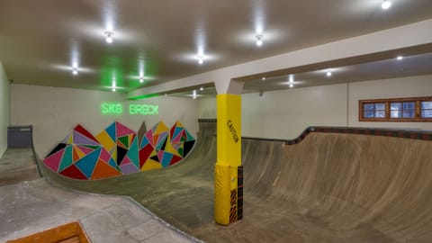 Recreation room with pool table, foosball, and colorful seating.