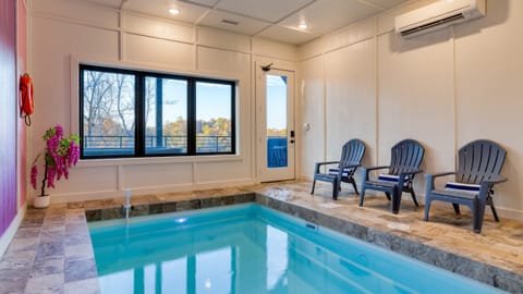 Bright, modern open-concept living with stylish pops of color and forest views.