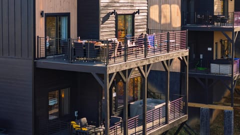 Spacious main-level deck with dining, lounge seating, and games—perfect for golden-hour hangs.