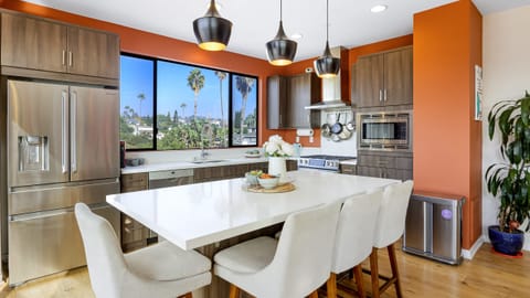 Modern kitchen with an island and stainless steel appliances.