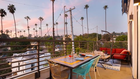 Balcony with dining table and outdoor living set.