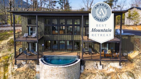 Terrace-level infinity pool and loungers overlooking sweeping Smoky Mountain vistas bathed in golden hour light.