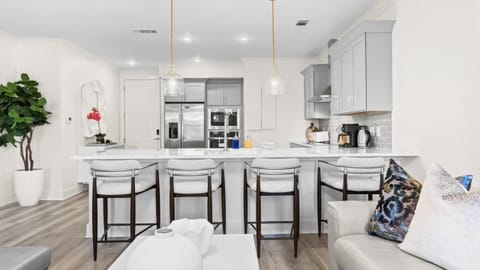 Fully equipped chef’s kitchen with stainless-steel appliances and a spacious breakfast bar.