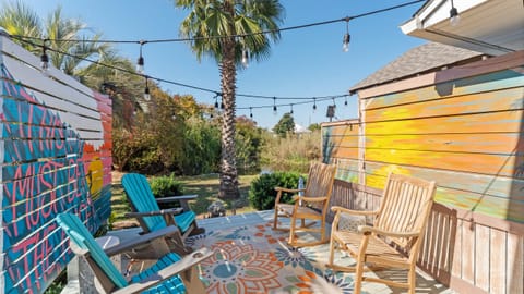 Backyard with seating and BBQ grill.