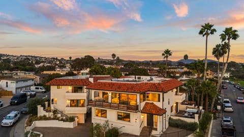 Stunning Newport Beach villa with coastal views, warm sunset skies, and inviting indoor-outdoor living.