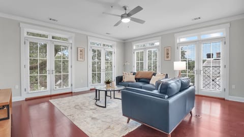 Bright, comfortable living area with sleek seating and a wall-mounted TV.