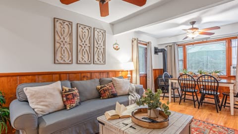 Living space with a comfortable sofa and a ceiling fan.