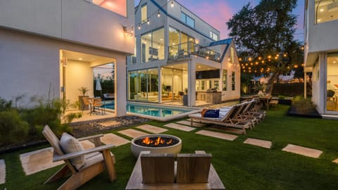 Enjoy the shared putting green under glowing string lights for a relaxing evening activity.