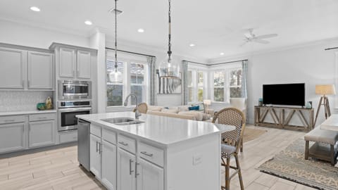 Gourmet kitchen with large center island and stainless steel appliances.