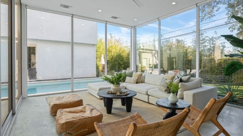 Unit 1304A: Bright, modern living area with floor-to-ceiling windows and stylish, comfortable seating.