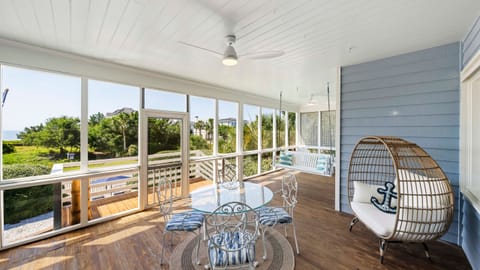 Coastal breezes and morning coffee—your favorite spot is waiting on the screened porch.