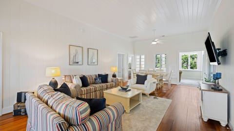 Relax in a sun-filled living space featuring classic beach-inspired decor and comfortable seating.