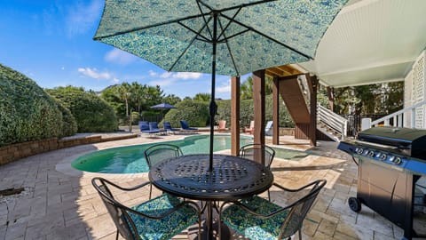 Shaded poolside dining perfect for BBQ lunches and warm island evenings.