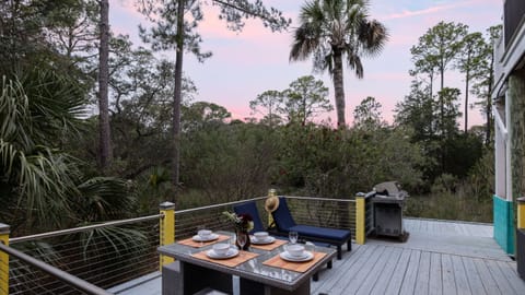 Sunset view from the deck, showing a casual seating area.