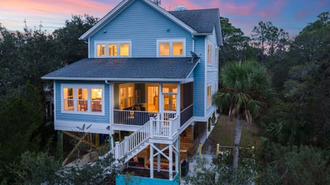 Beautiful elevated beach house exterior at sunset.
