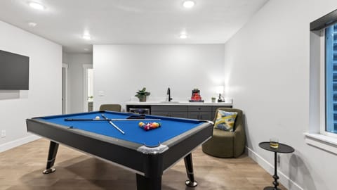 Dedicated game room with a pool table and lounge seating—perfect for friendly competition and relaxed nights in.