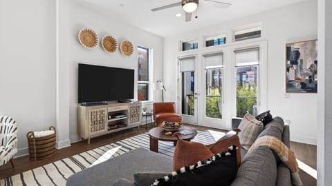 Spacious living room with large windows and modern decor.