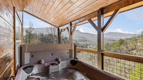 Relaxing covered hot tub overlooking the forest and mountains.