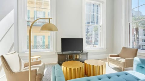 Bright and airy living room with plush seating and a TV to keep you entertained.