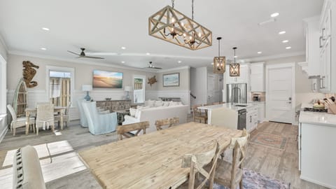 Dining space with a light wood table and seating for six.