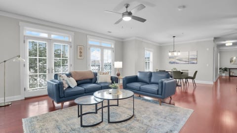 Spacious open living and dining area with modern décor, large windows, and natural light.