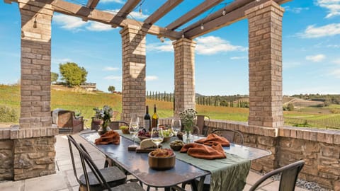 Long lunches and sunset dinners come naturally on this pergola-covered patio overlooking the vineyards.