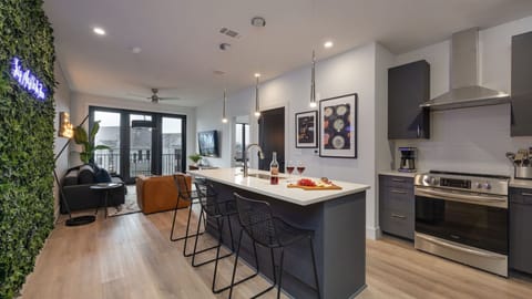 Open-concept layout showing the seamless transition from the kitchen island to the living area.