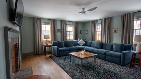 Spacious living room with plush sectional seating and abundant natural light.