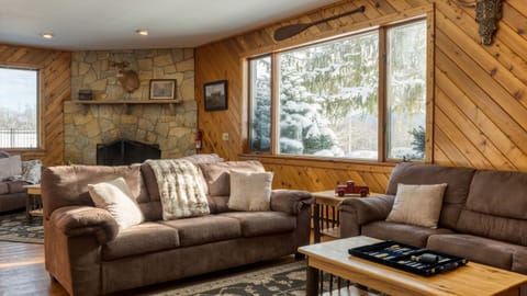 Cozy living room with ample seating, TV and a fireplace.