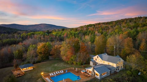 Escape to this private retreat featuring an illuminated pool, a relaxing hot tub, and spectacular mountain views.