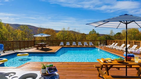 Dine, lounge, and unwind — the pool area offers multiple dining spaces and plenty of loungers for ultimate relaxation.