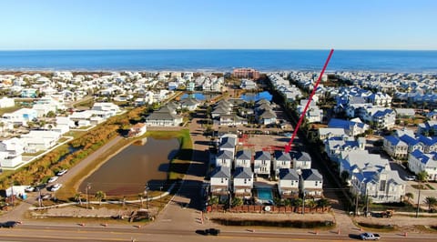 Aerial view showing the home’s location within the coastal community near the water.