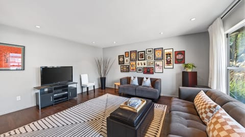 Comfortable living room with curated artwork—an inviting spot to unwind after a day of exploring.