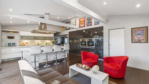 Cozy secondary lounge with fireplace and direct patio access—ideal for quieter moments or a change of scenery.