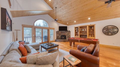 Large living area with a pool table and fireplace.