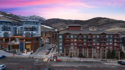 Scenic twilight view of the exterior and surrounding mountains.