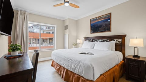 Bedroom 2 features a king bed, TV, desk and an ensuite bathroom.