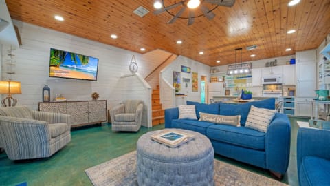 Bright, coastal-inspired living space with vaulted wood ceilings—perfect for gathering, relaxing, and unwinding after a day at the beach.