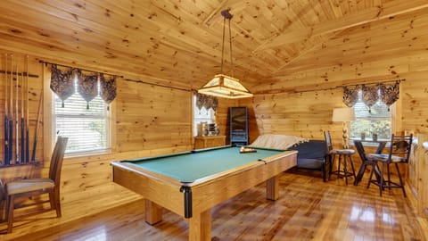 Upper-level game area with a full-sized pool table and arcade.